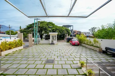 a driveway with a car parked in a building at Sree Bharat Residency in Alāndurai