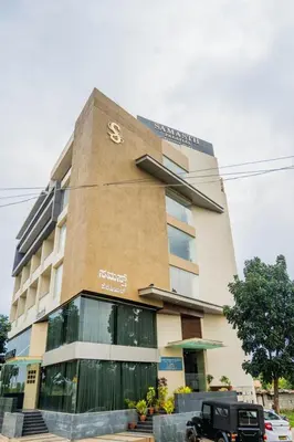 a building with a truck parked in front of it at Samasth Palatial in Mysore