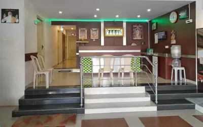 a lobby with stairs and chairs in a building at SUPREME RESIDENCY in Coimbatore