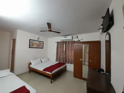 a bedroom with a bed and a ceiling fan at SUPREME RESIDENCY in Coimbatore