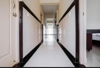 a hallway with two doors leading to a bedroom at HOTEL LEMONADE in Coimbatore