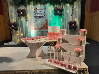 a table with a wedding cake and cupcakes on it at Emerald Royal Residency in Cochin