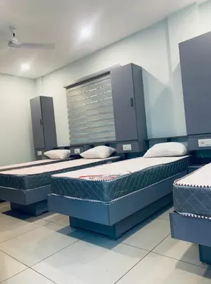 a room with three beds in a room at Emerald Royal Residency in Cochin