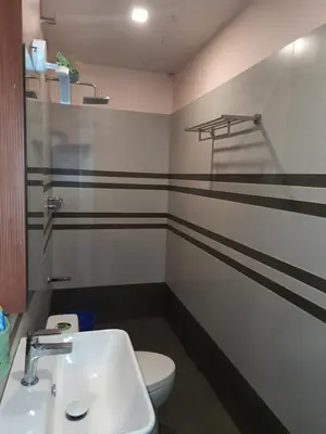 a bathroom with a white toilet and a sink at Emerald Royal Residency in Cochin