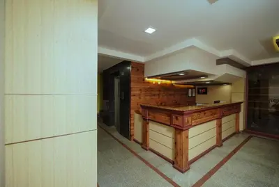 a hallway with a wooden counter in a building at Hotel oneiro in Trichūr