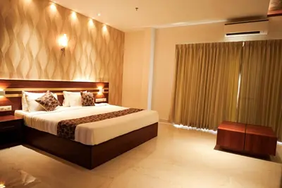 a hotel room with a bed and a window at Valluvanad Residency in Perintalmanna
