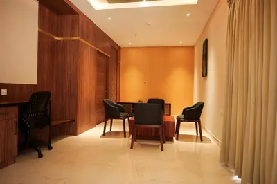 a waiting room with chairs and a table at Valluvanad Residency in Perintalmanna