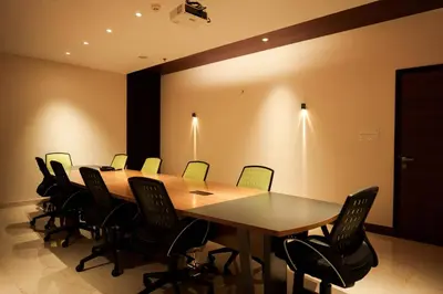 a conference room with a long table and chairs at Valluvanad Residency in Perintalmanna