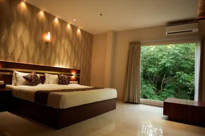 a bedroom with a large bed and a large window at Valluvanad Residency in Perintalmanna