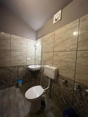 a bathroom with a toilet and a sink at Kizhunna rock beach house in Kannur