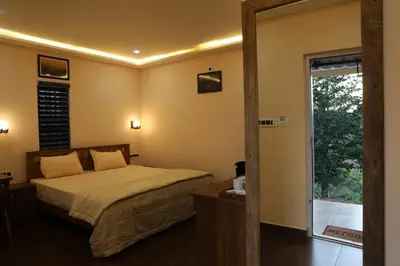 a bedroom with a bed and a sliding glass door at Agronest Farm by LivingStone in Sultan Bathery