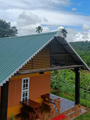a small house with a picnic table in front of it at Agronest Farm by LivingStone in Sultan Bathery