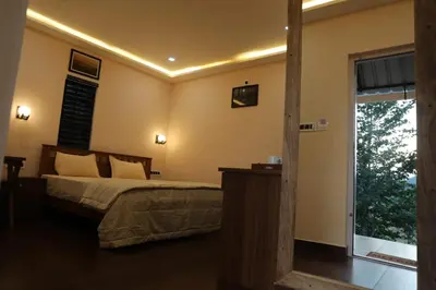 a bedroom with a bed and a sliding glass door at Agronest Farm by LivingStone in Sultan Bathery