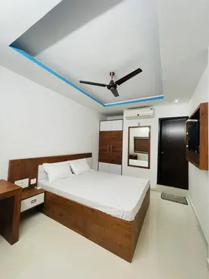 a bedroom with a bed and a ceiling fan at Zam Zam Residency in Cheruppulasseri