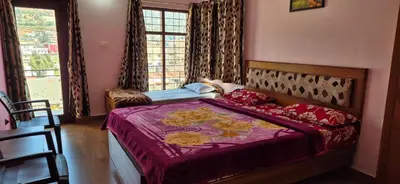 a bedroom with a bed with a purple comforter and a window at Karpagam Residency in Ooty