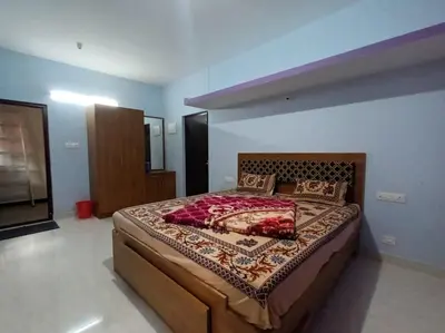 a bedroom with a large bed in a room at Karpagam Residency in Ooty