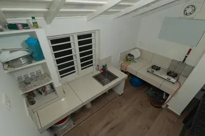 an overhead view of a kitchen with a sink at Babu's Homestay By Lexstays in Mananthavady