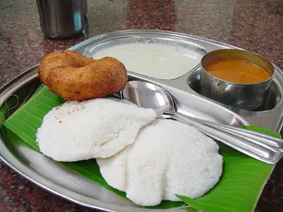 a plate of food with rice and a heart shaped at Babu's Homestay By Lexstays in Mananthavady