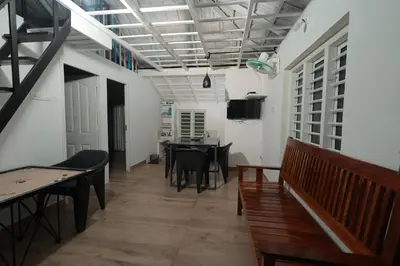 a dining room with tables and chairs and a tv at Babu's Homestay By Lexstays in Mananthavady