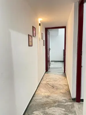 an empty hallway with a door leading to a room at WHITE HOUSE - 3BHK Elite Apartment in Coimbatore