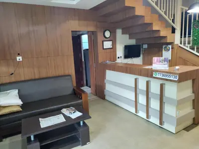 a living room with a couch and a staircase at Meghdoot river resort in Ernakulam