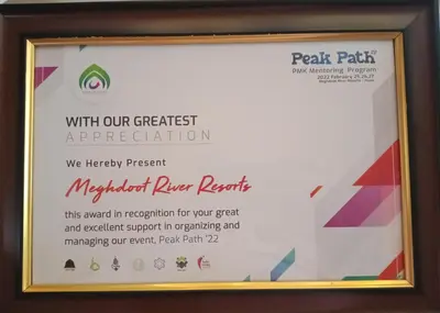 a framed sign in a wooden frame with a certificate at Meghdoot river resort in Ernakulam