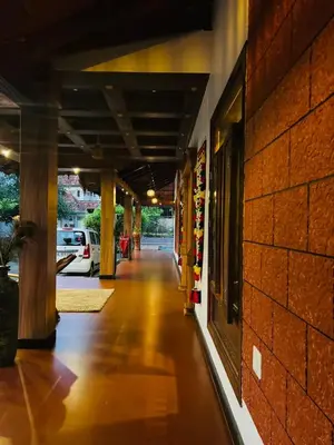 an empty hallway of a building with a brick wall at Vajra Ayurveda and Yoga Retreat in Cochin
