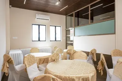a room with tables and chairs and a projection screen at THE RUNWAY HOTEL in Cochin