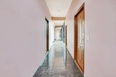 a corridor of a building with a door and a hallway at Super Collection O Coorg in Madikeri