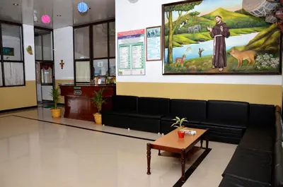 a waiting room with a couch and a table at AC MIST in Munnar