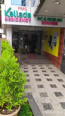 a store front with plants in front of a building at Kallada Residency in Perintalmanna