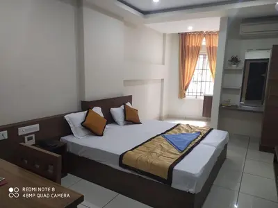 a bedroom with a large bed in a room at Kallada Residency in Perintalmanna