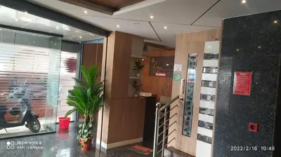 a lobby with a scooter parked in a building at Kallada Residency in Perintalmanna