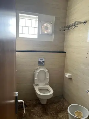 a small bathroom with a toilet and a window at PPH Living Athithi Inn Corporate Stay in Coimbatore