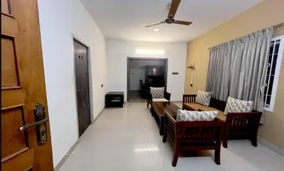 a living room with a table and chairs at PPH Living Athithi Inn Corporate Stay in Coimbatore