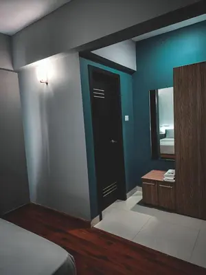 a bedroom with a black door and a mirror at GDC - Apartment suites in Ernakulam