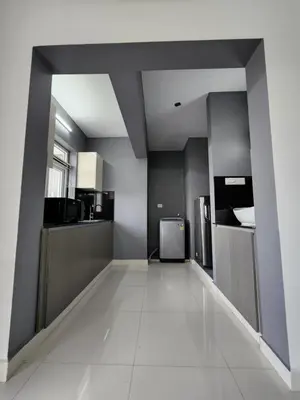 a large room with a kitchen with a refrigerator at GDC - Apartment suites in Ernakulam