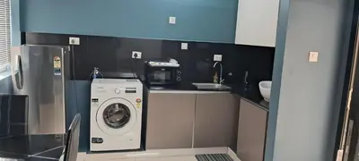 a kitchen with a washing machine in a kitchen at GDC - Apartment suites in Ernakulam