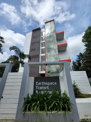 a building with a sign for the entrance to an embassy transit at GDC - Apartment suites in Ernakulam