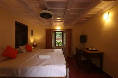 a bedroom with a large white bed and a window at Avadale Coorg - Stag Groups Not Allowed in Ammatti