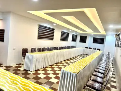a conference room with rows of chairs and a checkered floor at NIDHI RESIDENCY in Guruvāyūr