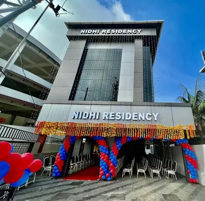 a building with chairs and balloons in front of it at NIDHI RESIDENCY in Guruvāyūr
