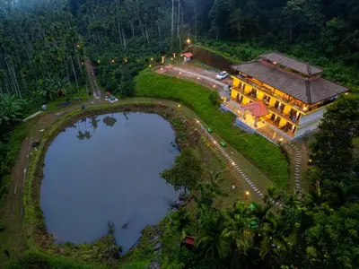 an aerial view of a house with a pool at The Hosteller Coorg Rainforest, Madikeri in Madikeri