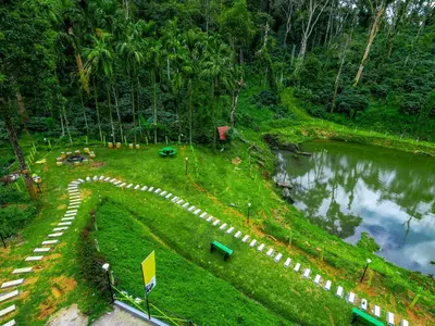 an aerial view of a park next to a lake at The Hosteller Coorg Rainforest, Madikeri in Madikeri