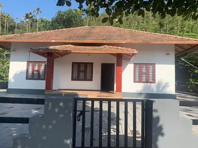 a small house with a gate in front of it at Perya Hills in Periya