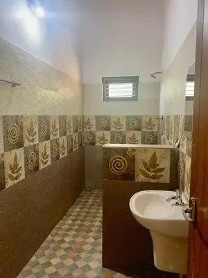 a bathroom with a toilet and a sink at Perya Hills in Periya