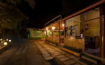 a building with lights on the side of it at night at Misty Morning Resorts Wayanad in Ambalavayal