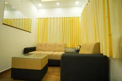 a living room with two chairs and a couch at Misty Range Resorts , Marayoor in Marayoor