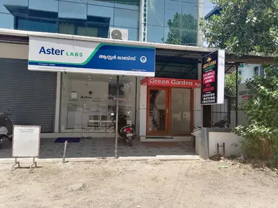 a store front with a sign in front of it at Green Garden Apartments in Kodungallūr