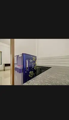 a blue refrigerator with flowers on it in a room at Subramania Arcade in Trichūr